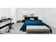 Bright bedroom with carpet, natural light, bed with blue bedding and a bench at 812 Benoi Dr, Davenport, FL 33896