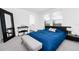 Bright bedroom with carpet, natural light, bed with blue bedding, a bench and a mirror at 812 Benoi Dr, Davenport, FL 33896