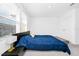 Cozy bedroom with carpet, natural light, bed with blue bedding, a bench, and bedside tables at 812 Benoi Dr, Davenport, FL 33896