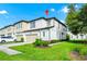 Beautiful two-story townhouse with a well-manicured lawn, neutral paint, and attached garage at 812 Benoi Dr, Davenport, FL 33896