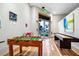 Bright game room features foosball, shuffleboard, and wood floors with an exit for easy access at 812 Benoi Dr, Davenport, FL 33896