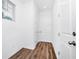 Hallway with wood-look flooring, white doors, and a window providing natural light at 812 Benoi Dr, Davenport, FL 33896