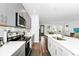 Modern kitchen with stainless steel appliances, gray cabinets, and a kitchen island overlooking the living area at 812 Benoi Dr, Davenport, FL 33896