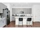 Modern kitchen with gray cabinets, stainless steel appliances, and a large island with seating at 812 Benoi Dr, Davenport, FL 33896