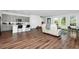 Open-concept living room featuring a large sofa, kitchen, and ample natural light at 812 Benoi Dr, Davenport, FL 33896