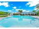 Large, bright outdoor pool with plenty of lounge chairs, umbrellas and lush landscaping at 812 Benoi Dr, Davenport, FL 33896