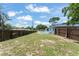 A spacious backyard with a private pool and a wooden fence offers plenty of outdoor living space at 945 Shawna Shrs, Haines City, FL 33844