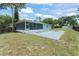 A screened lanai and private pool offer an inviting outdoor space in the backyard at 945 Shawna Shrs, Haines City, FL 33844