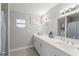 Bright bathroom featuring a double vanity, modern fixtures, and a shower with tiled walls at 945 Shawna Shrs, Haines City, FL 33844
