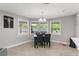 Inviting dining area with a modern chandelier, large windows, and views of the surrounding landscape at 945 Shawna Shrs, Haines City, FL 33844