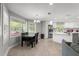 Bright dining area adjacent to the kitchen, featuring a modern chandelier and large windows at 945 Shawna Shrs, Haines City, FL 33844