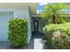 View of the Front Entrance featuring a well-maintained walkway and mature landscaping at 945 Shawna Shrs, Haines City, FL 33844