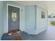 Entrance of this home showcases a detailed door and covered porch, offering a welcoming appeal at 945 Shawna Shrs, Haines City, FL 33844