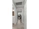 Hallway with multiple doors leading to the bathroom and bedroom/office space, all with tile floors at 945 Shawna Shrs, Haines City, FL 33844