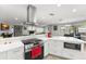 Well-designed kitchen featuring stainless steel appliances, a modern range hood, and ample counter space at 945 Shawna Shrs, Haines City, FL 33844
