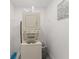 Efficient laundry area with stacked washer and dryer units and ample space for storage at 945 Shawna Shrs, Haines City, FL 33844