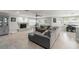 Open-concept living room with a gray sectional sofa, fireplace, and adjacent dining area at 945 Shawna Shrs, Haines City, FL 33844