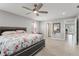 Spacious main bedroom suite features a ceiling fan, ensuite bathroom, and access to the sunroom at 945 Shawna Shrs, Haines City, FL 33844