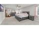 Well-lit main bedroom features a ceiling fan, a large bed, a dresser, and plenty of space at 945 Shawna Shrs, Haines City, FL 33844