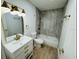 Updated bathroom features a tub and shower, neutral tile, and modern fixtures at 1055 Kensington Park Dr # 205, Altamonte Springs, FL 32714