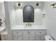 Bathroom featuring a modern vanity, round mirror and decorative sconces at 1055 Kensington Park Dr # 205, Altamonte Springs, FL 32714