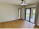 Bright bedroom with hardwood floors and sliding glass doors to a private balcony at 1055 Kensington Park Dr # 205, Altamonte Springs, FL 32714