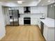 Contemporary kitchen boasts white cabinets, stainless steel appliances, and quartz countertops at 1055 Kensington Park Dr # 205, Altamonte Springs, FL 32714
