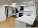 Modern kitchen featuring white cabinets, stainless steel appliances, and quartz countertops at 1055 Kensington Park Dr # 205, Altamonte Springs, FL 32714
