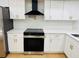Close-up of a modern kitchen showcasing white cabinets and stainless steel appliances at 1055 Kensington Park Dr # 205, Altamonte Springs, FL 32714