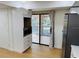 Bright kitchen with white cabinets, stainless steel appliances, and a sliding glass door to the balcony at 1055 Kensington Park Dr # 205, Altamonte Springs, FL 32714