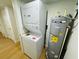 Laundry room featuring a stackable washer and dryer unit, and a water heater at 1055 Kensington Park Dr # 205, Altamonte Springs, FL 32714