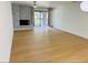 Bright living room with decorative fireplace, ceiling fan, and sliding glass doors to a balcony at 1055 Kensington Park Dr # 205, Altamonte Springs, FL 32714