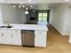 Open-concept living space connected to a kitchen with an island and a cozy fireplace at 1055 Kensington Park Dr # 205, Altamonte Springs, FL 32714
