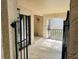 Covered outdoor patio with stone flooring and a secure metal gate for privacy and security at 1055 Kensington Park Dr # 205, Altamonte Springs, FL 32714