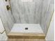 Detailed view of a modern tiled shower with gold accents and a patterned mosaic floor at 1055 Kensington Park Dr # 205, Altamonte Springs, FL 32714