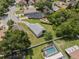 Aerial view of the property showing a home with fenced yard, lush trees, and a pool, in a serene neighborhood setting at 10708 Brice Ct, Orlando, FL 32817