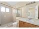 Bathroom featuring a large mirror, single sink vanity, and a tiled walk-in shower at 10708 Brice Ct, Orlando, FL 32817