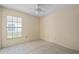 Bedroom featuring tile flooring, a window, and walls painted in a cream color at 10708 Brice Ct, Orlando, FL 32817
