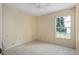 Bedroom featuring tile flooring, a window, and walls painted in a cream color at 10708 Brice Ct, Orlando, FL 32817