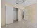 Bedroom with a ceiling fan, closet, tile flooring and cream colored walls at 10708 Brice Ct, Orlando, FL 32817