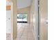 Neutral hallway with tile flooring leading to the living space and screened in patio at 10708 Brice Ct, Orlando, FL 32817