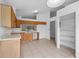 Spacious kitchen with tiled flooring, wood cabinets, and access to pantry and living area at 10708 Brice Ct, Orlando, FL 32817