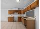 Kitchen featuring tiled floors, wood cabinets and a pass-through to living area at 10708 Brice Ct, Orlando, FL 32817