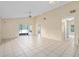 Open-concept living room featuring tile floors, ceiling fan, and sliding glass doors to lanai at 10708 Brice Ct, Orlando, FL 32817