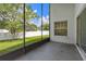 View from screened in patio out to fenced backyard and lush trees at 10708 Brice Ct, Orlando, FL 32817