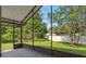 Screened patio overlooking a lush backyard with mature trees and a white privacy fence at 10708 Brice Ct, Orlando, FL 32817
