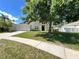 Beautiful single-story home with an attached garage, a manicured lawn, and mature shade trees at 109 Belgian Way, Sanford, FL 32773
