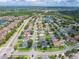 An impressive aerial view reveals a neighborhood with a nearby pond, green spaces, and well-maintained landscaping at 1224 Blackwater Pond Dr, Orlando, FL 32828