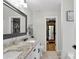 Bright bathroom with a granite countertop, double sink vanity, toilet, and a large mirror at 1224 Blackwater Pond Dr, Orlando, FL 32828