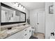 Bathroom featuring granite counters, a double sink vanity, and modern dark hardware at 1224 Blackwater Pond Dr, Orlando, FL 32828